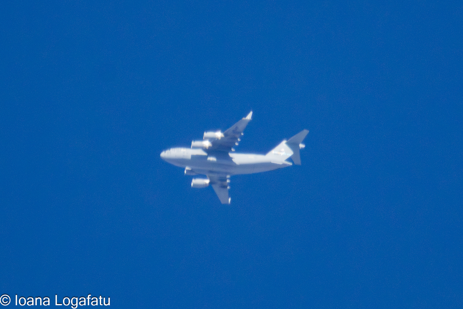 Airplane soaring through a clear blue sky